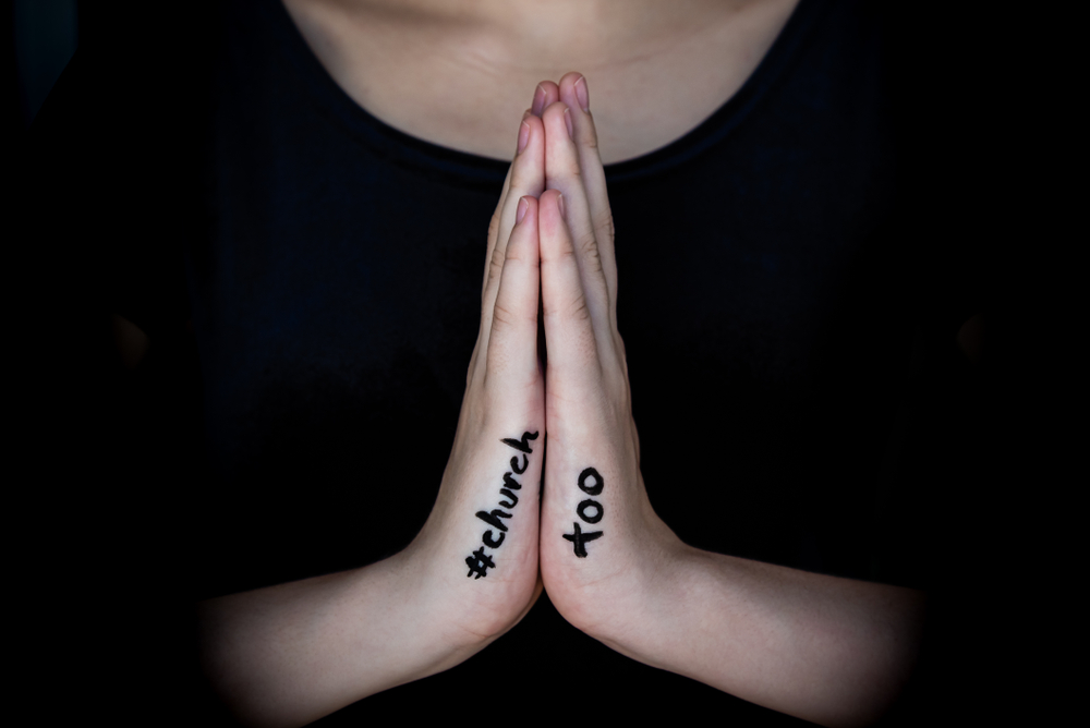 Hands in prayer symbolizing hope and healing for survivors of church sexual abuse in Boston