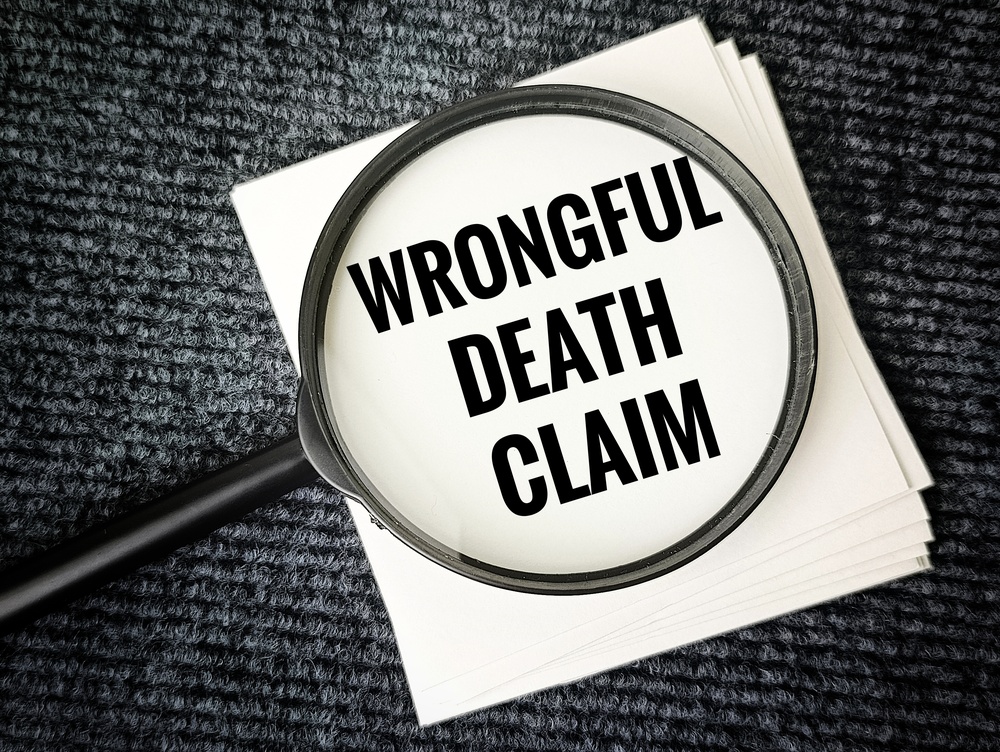 Wrongful death claim concept with magnifying glass and document for Springfield Massachusetts