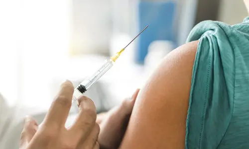 doctor administering a vaccine to a patient